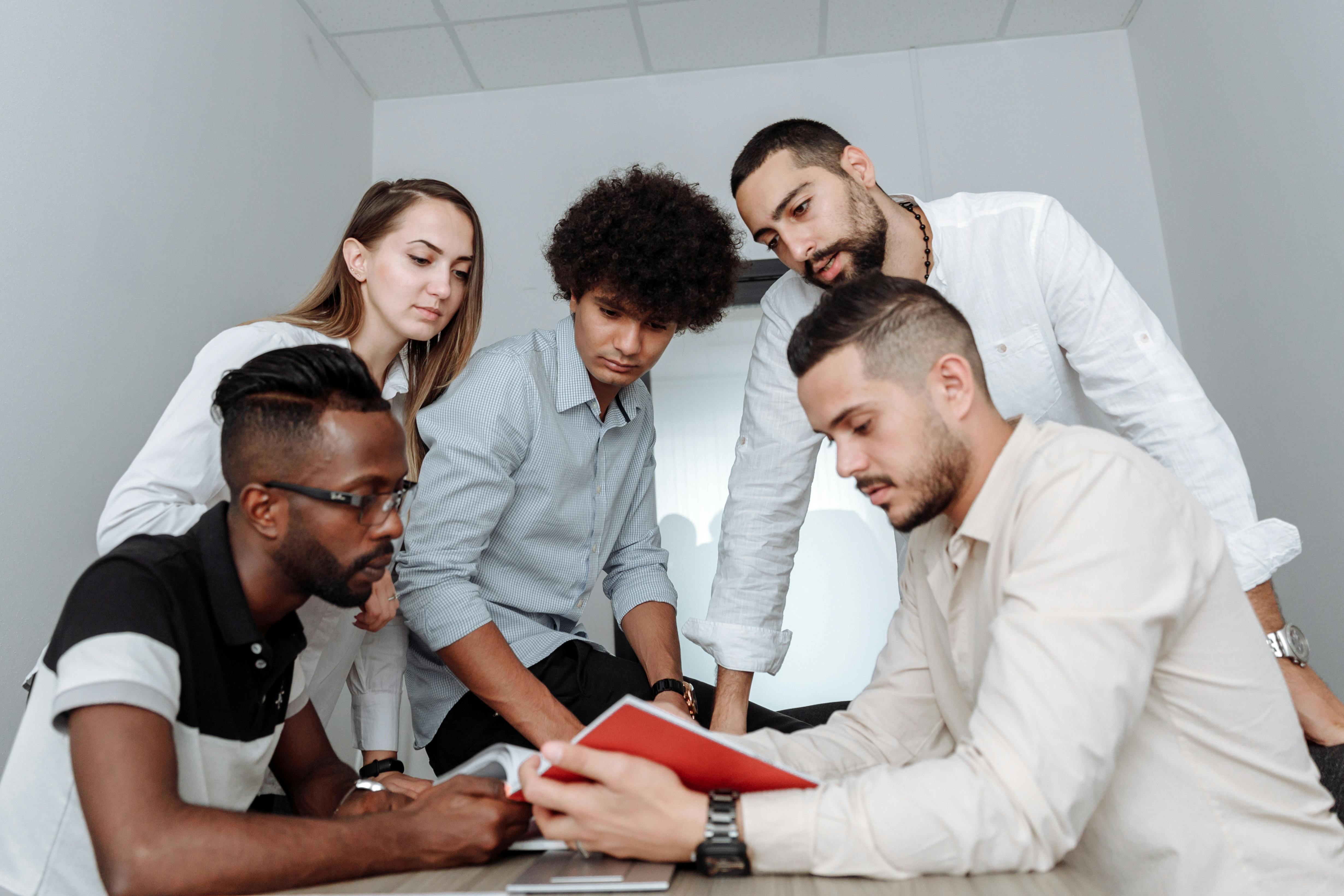 Diverse business team collaborating in a modern office meeting