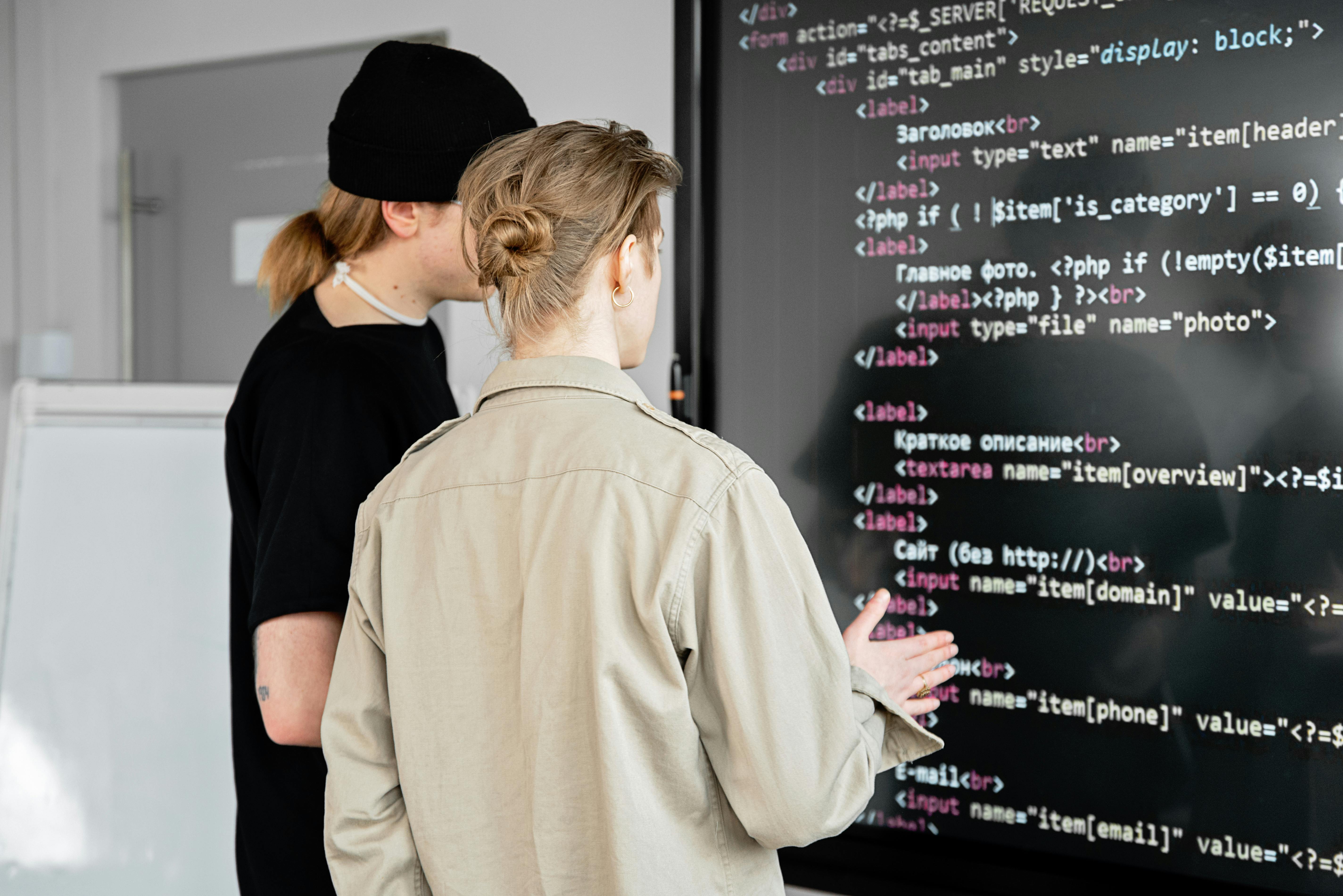 Developers reviewing code and integration architecture on a large display