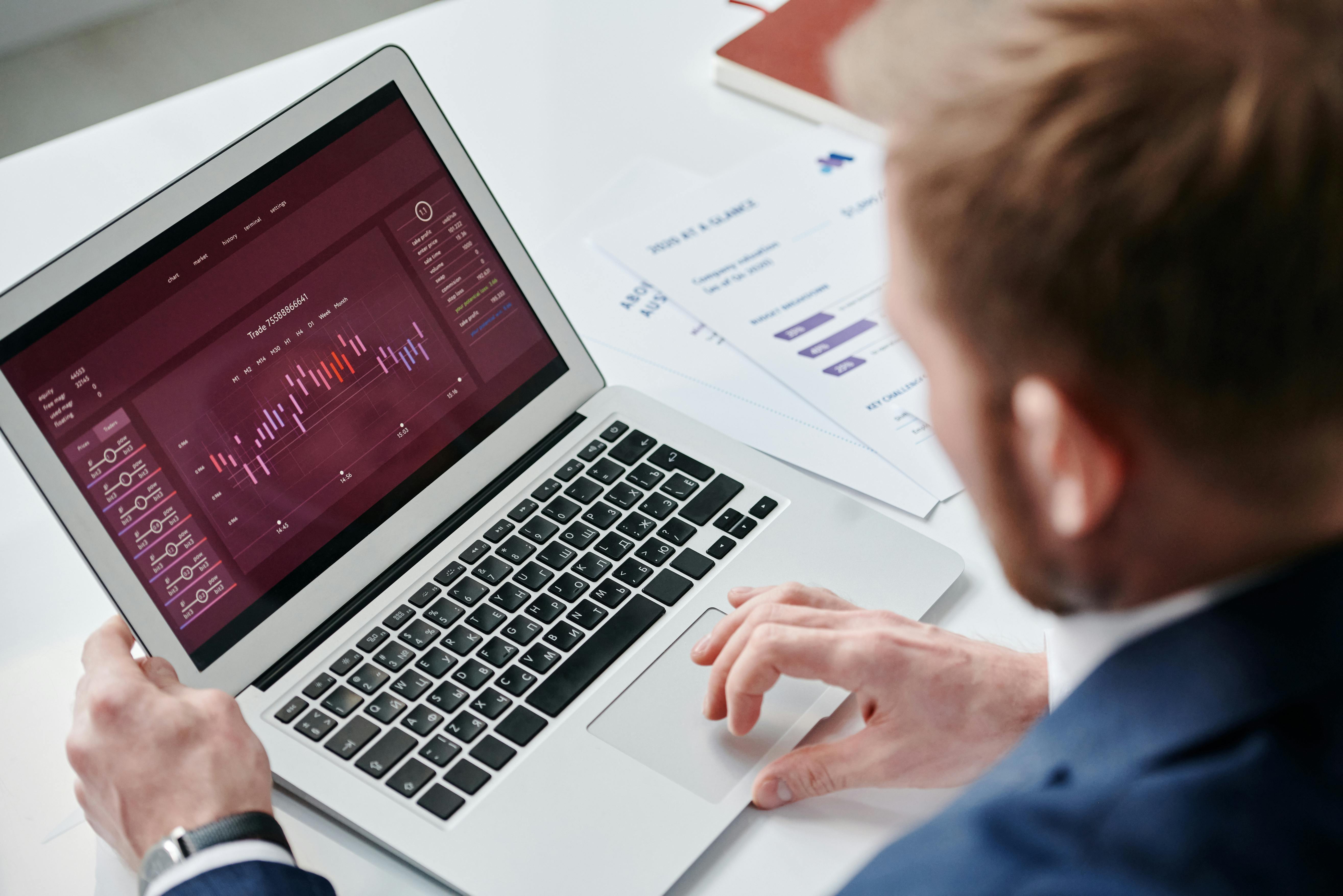 Business professional reviewing analytics and data on a laptop