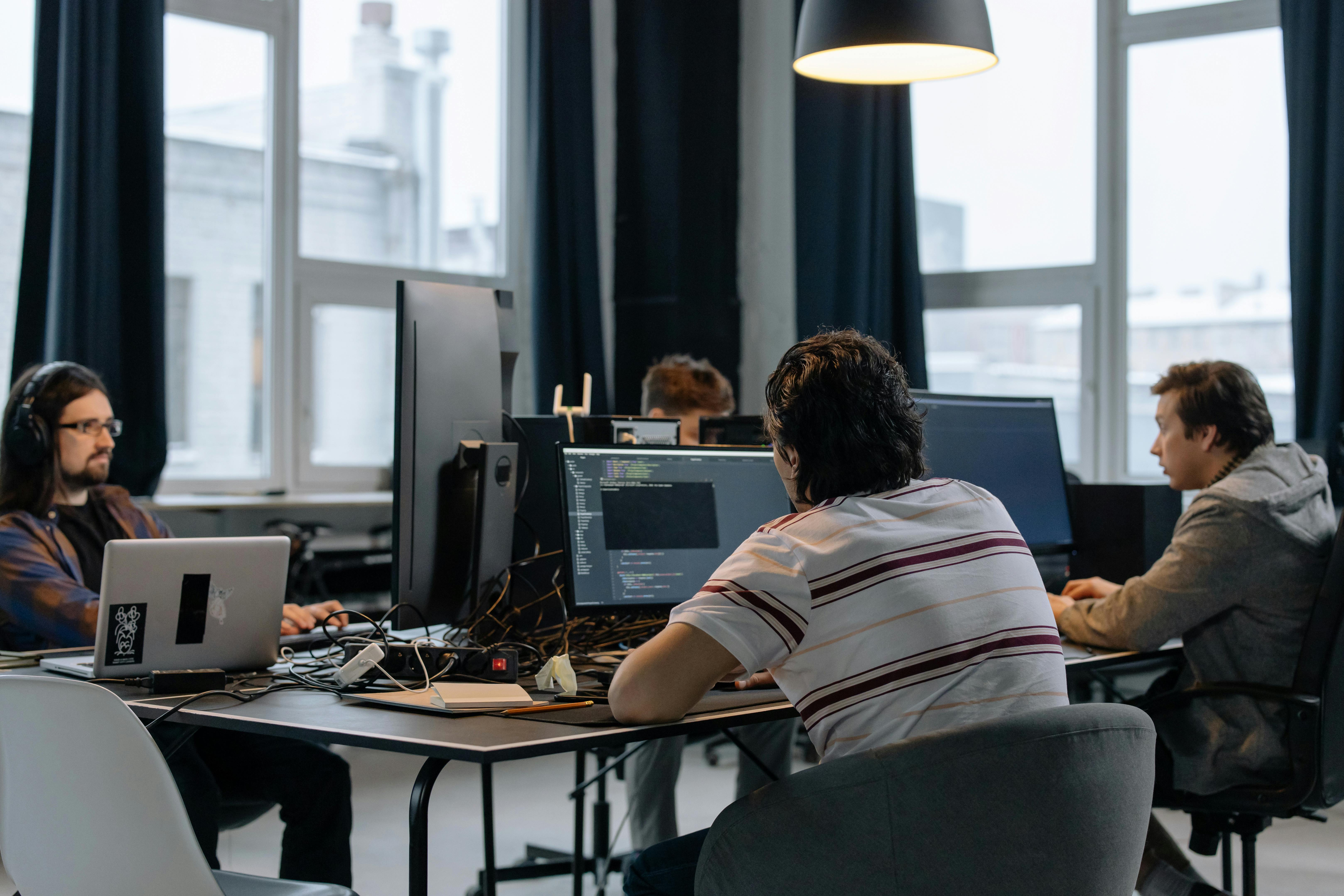 Technology team working at computers on integration delivery